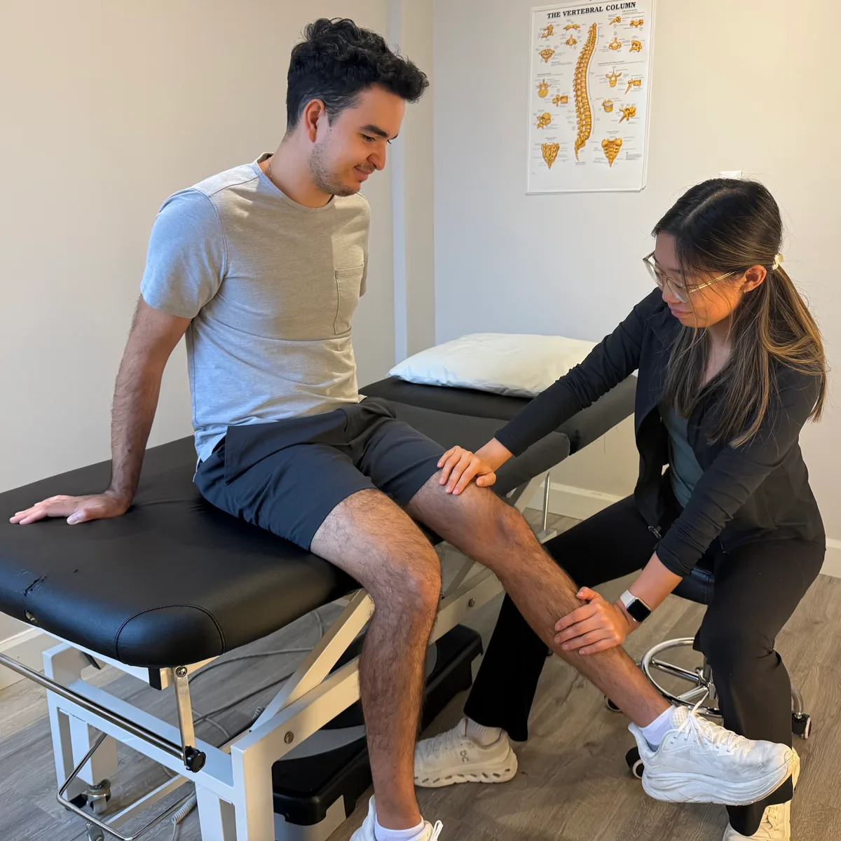 Physiotherapist assessing a patient’s knee at Altitude Physiotherapy.