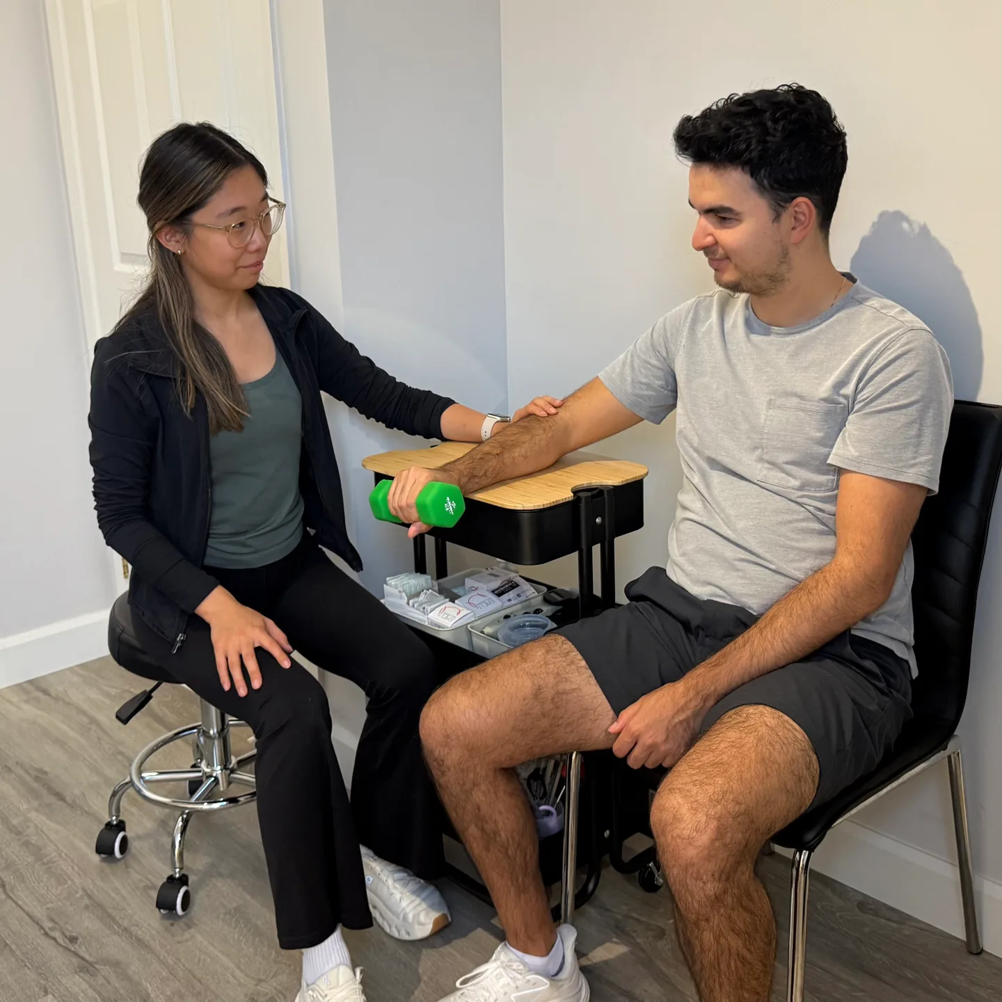 Physiotherapist assessing a patient’s shoulder movement at Altitude Physiotherapy.